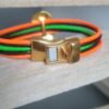 Bracelet femme en cuir rond 2mm orange, vert et marron, passant martelé doré