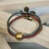 Bracelet femme , trois cuirs ronds et grosse marguerite bronze